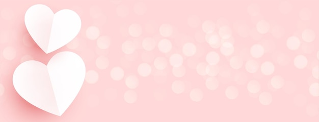 Free vector beautiful paper hearts on pink bokeh banner