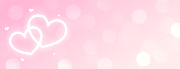 Красивые два неоновых светящихся белых сердца на розовом фоне боке