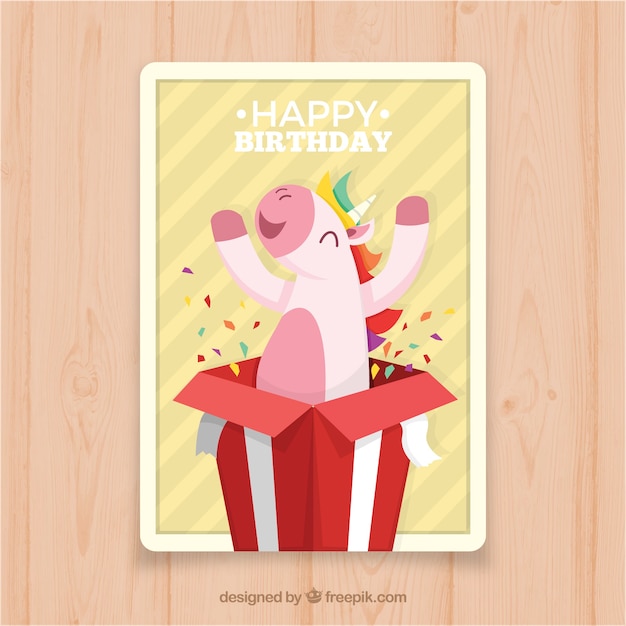 Free vector birthday card with a unicorn coming out of a gift