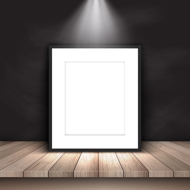 Free vector blank picture under spotlight leaning against chalkboard wall