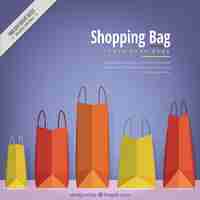 Free vector blue background with flat shopping bags