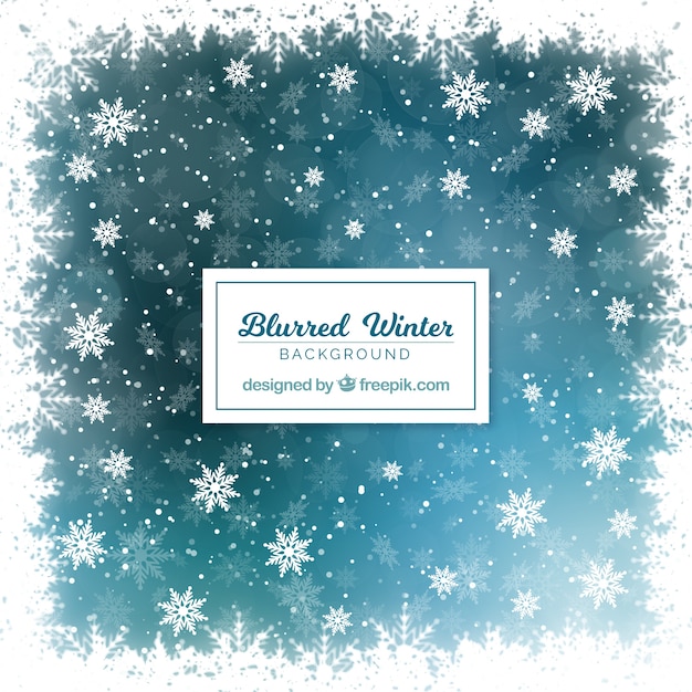 Free vector blurred blue winter background with snowflakes