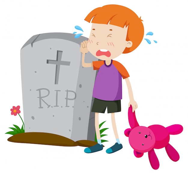 Boy crying in tears at gravestone