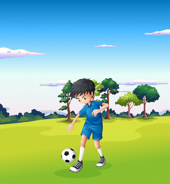 森でサッカーをしている少年