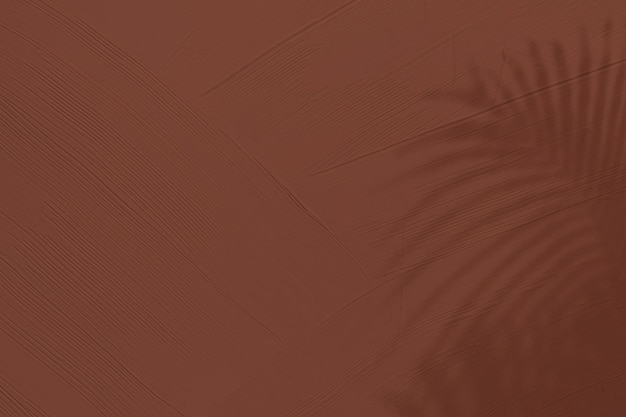 Коричневый текстурированный фон с тенью тропических листьев