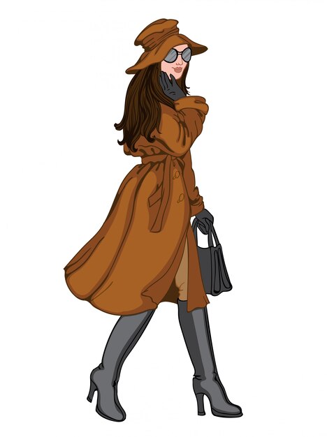 포즈를 취하는 그녀의 얼굴에 미소 가을 옷에 갈색 머리 여자. 갈색 모자, 코트, 바지, 검은 장갑, 선글라스, 핸드백 및 부츠