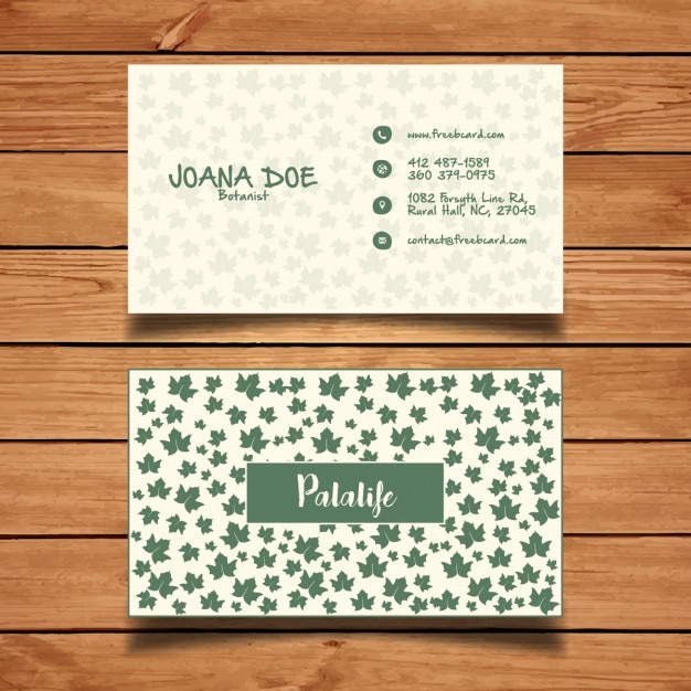 Free vector business card with green leaves