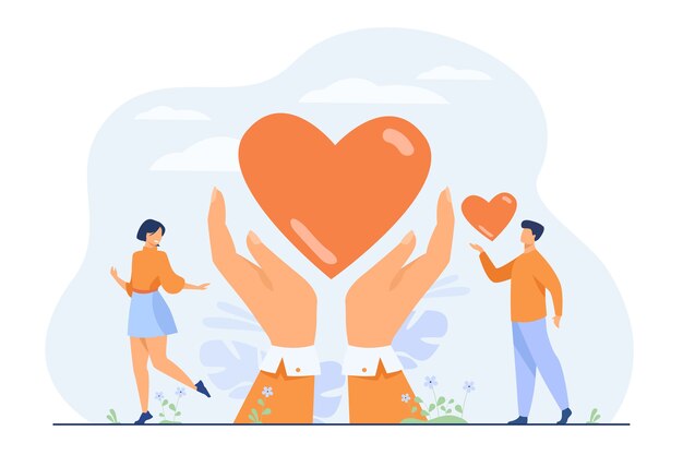 Charity and donation concept. Hands of volunteers holding and giving heart.