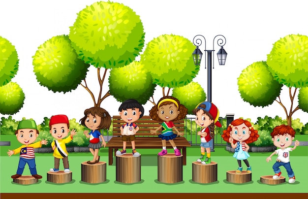 Children standing on log in the park