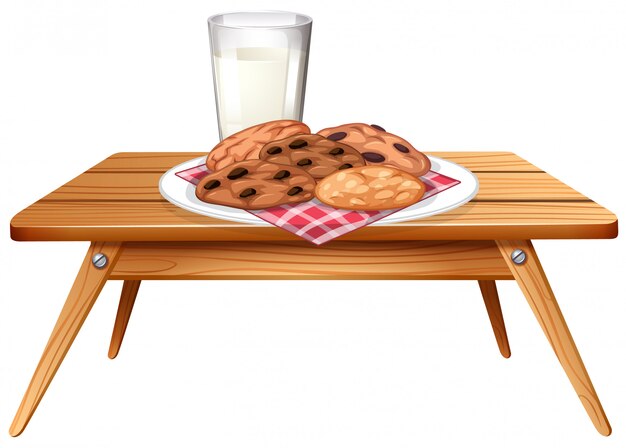 Шоколадное печенье и молоко на деревянном столе