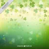 Free vector clovers green bokeh background