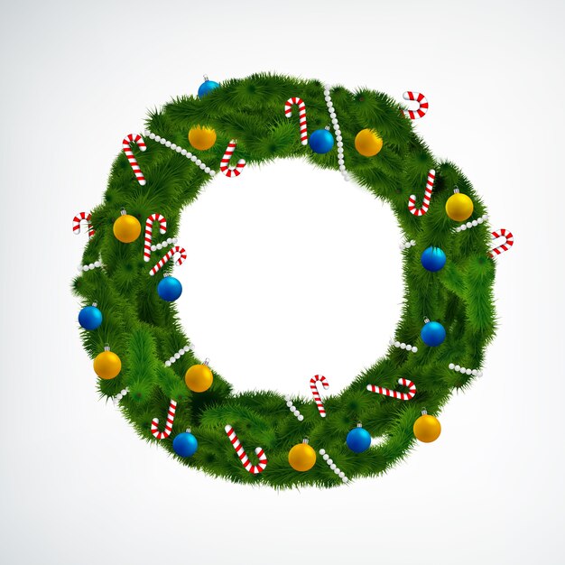 Coniferous christmas wreath decorated with balls and candies on white