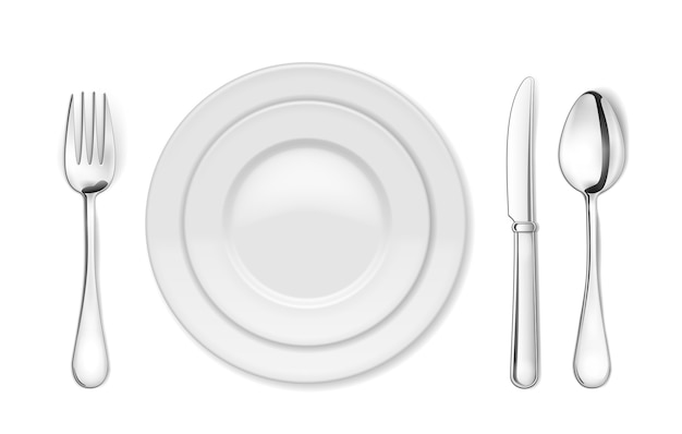 Обеденная тарелка, нож, вилка и ложка изолированные
