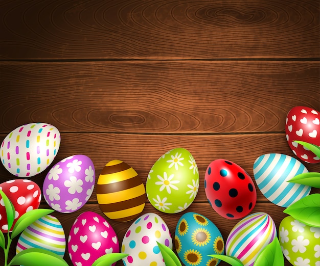 Easter background with top view of wooden table texture with colourful eggs and green leaves images  illustration