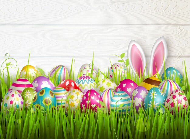 Easter composition with colourful images of festive easter eggs on green grass surface with bunny ears  illustration