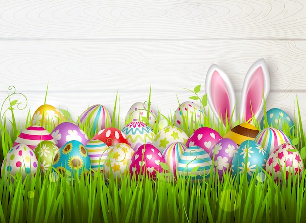 Easter composition with colourful images of festive easter eggs on green grass surface with bunny ears  illustration