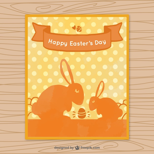 Free vector easter greeting card with orange rabbits