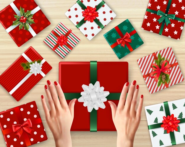 Female hands and decorated cardboard gift boxes of different color realistic background