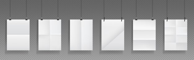 Folded blank posters hang with binder clips, white paper sheets with crossing creases and holders.