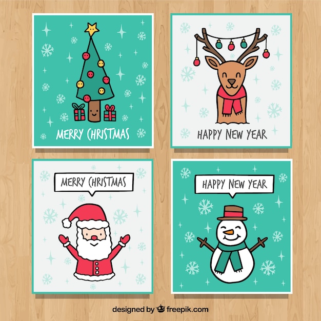 Free vector four hand drawn greeting cards for christmas