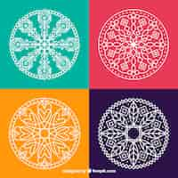 Free vector four hand drawn mandalas