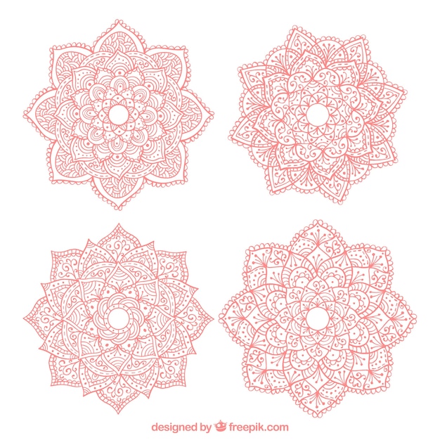 Free vector four hand-drawn pink mandalas
