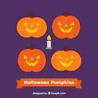 Free vector four pumpkins on a purple background