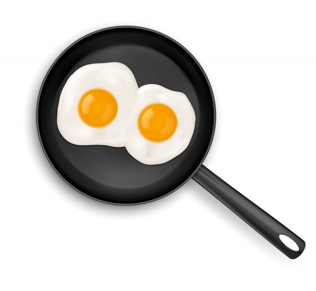 Fried eggs on frying pan top view isolated