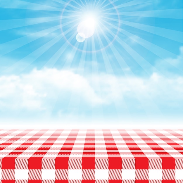 青い曇り空を背景にギンガムピクニックテーブル