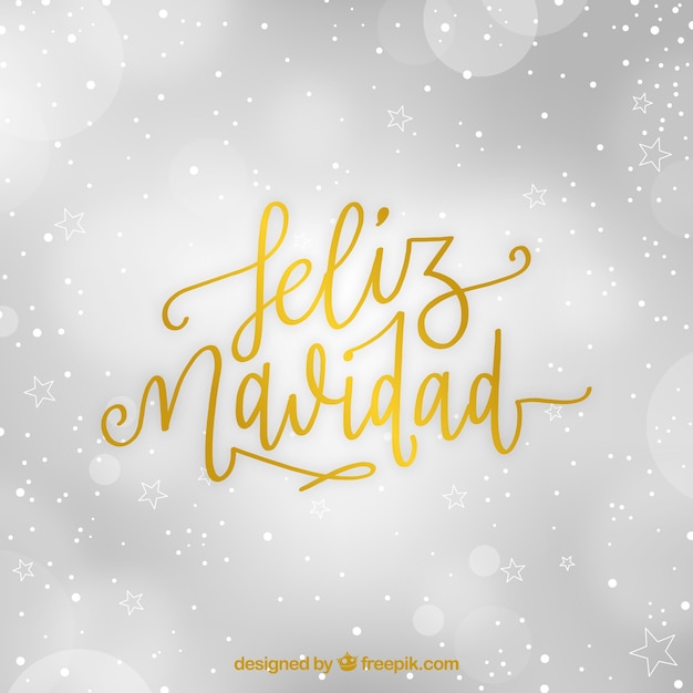 Free vector golden lettering of merry christmas with bokeh background