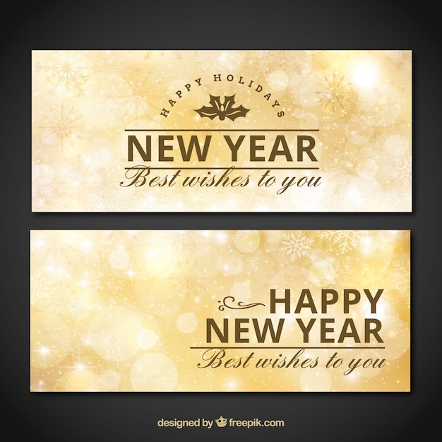 Golden new year banners with snowflakes and bokeh effect