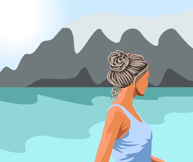 湖と山々を見ている青いタンクトップの白髪の女性