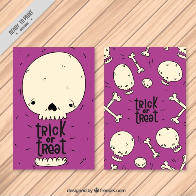 Free vector halloween cards of hand drawn skull and bones