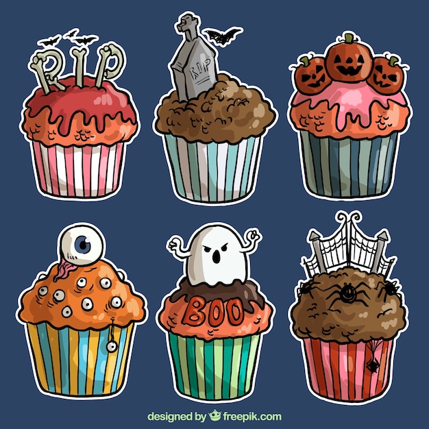 Free vector hand drawn cupcakes of halloween