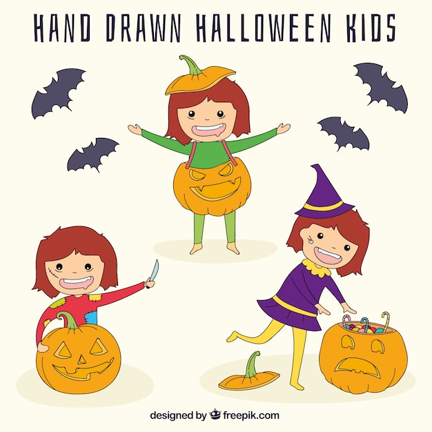 Bambini di halloween disegnati a mano con zucche