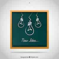 Free vector hand drawn light bulbs on blackboard