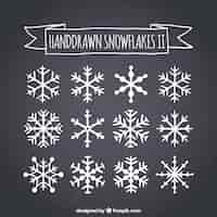 Free vector hand drawn snowflakes on blackboard