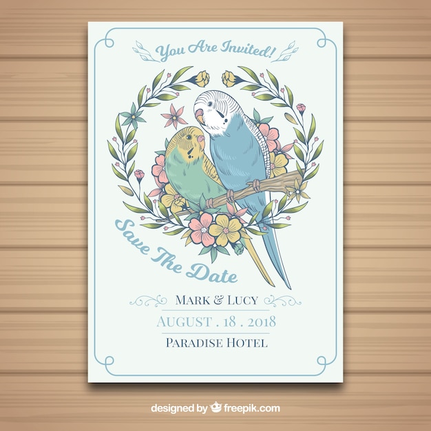 Free vector hand drawn wedding card with parrots