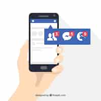 Free vector hand holding phone with facebook notifications