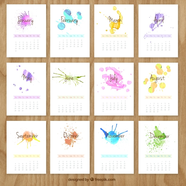 Free vector hand painted calendar with watercolor splashes