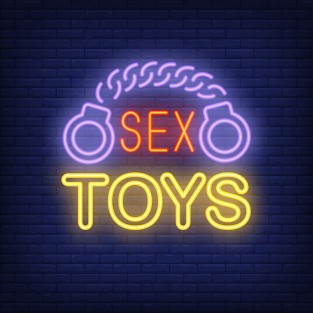 Free vector handcuffs with sex toys lettering. neon sign on brick background.