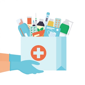 Hands in disposable gloves with paper bag with medicines, drugs, pills and bottles inside