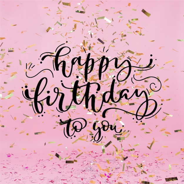 Free vector happy birthday lettering with golden confetti