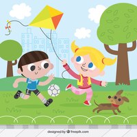 Happy children playing with kite and ball