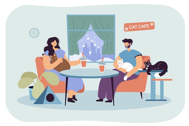 Coppia felice seduta insieme al cat cafe