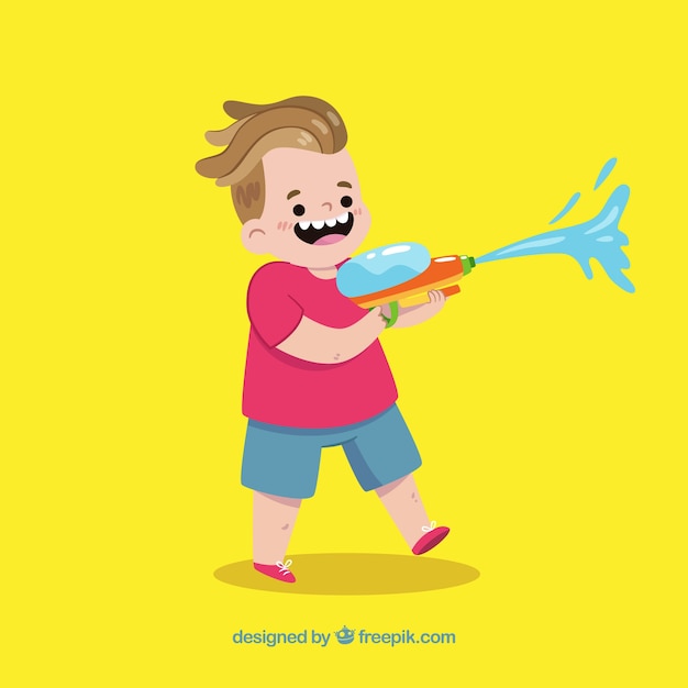 Счастливый ребенок, играющий с водяным пистолетом