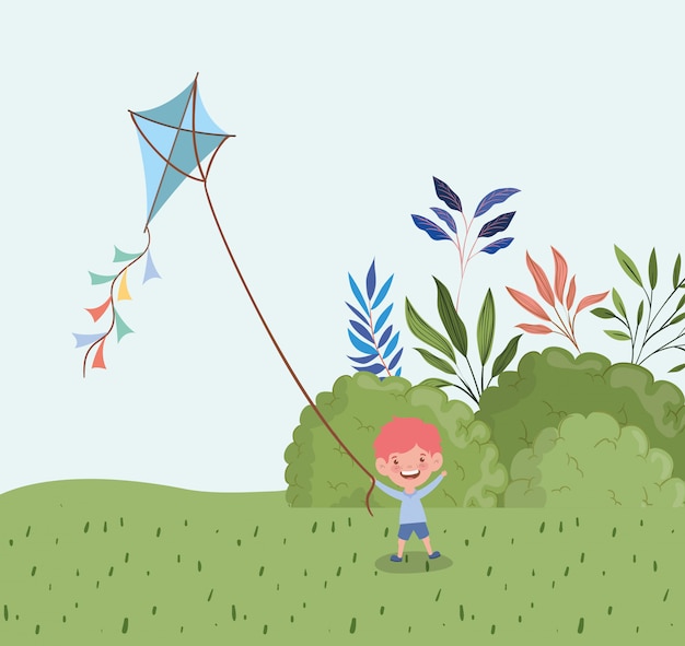 Happy little boy flying kite in the landscape