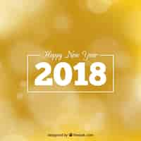 Free vector happy new year 2018 golden blurred background