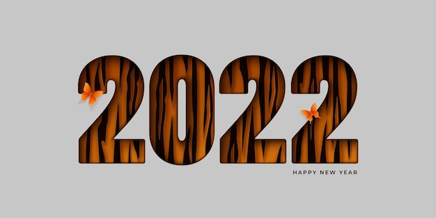 Happy new year abstract background. paper cut 2022 numerals  with tiger spots on a light backdrop