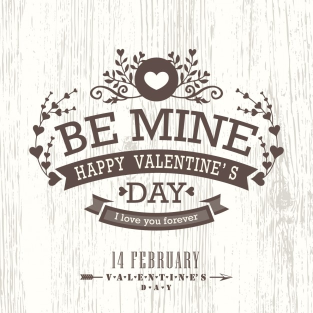 Free vector happy valentine on a wooden background